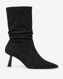 Celestine black boots, side view showing the gathered shaft and slender heel.