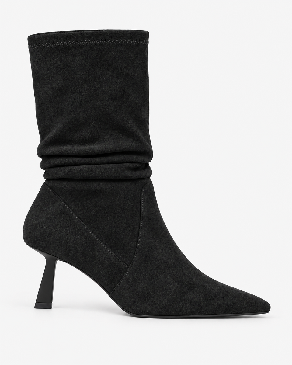 Celestine black boots, side view showing the gathered shaft and slender heel.