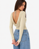 Three-quarter back view of the Esme apricot top with a draped open back and tie at the neck