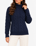 Harriet Dark Blue cable-knit roll-neck jumper, close-up front view of the cable-knit pattern and ribbed hem