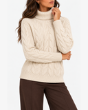 Harriet Apricot cable-knit roll-neck jumper, close-up of the roll neck, cable-knit front and ribbed cuffs