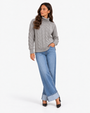 Harriet Grey cable-knit roll-neck jumper, full-length styling with wide-leg blue jeans