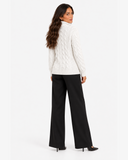 Harriet White cable-knit roll-neck jumper, back view with black wide-leg trousers