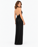 Woman wearing the Isolde black halter maxi dress, full-length back view