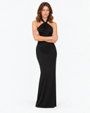 Woman wearing the Isolde black halter maxi dress in a crossed-arm pose