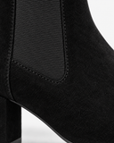 Lenora black boots, close-up of the elastic side panel and ankle seam.