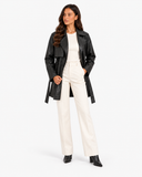 Full-length view of Maren black faux leather trench coat worn open