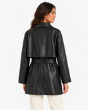Back view of Maren black faux leather trench coat with storm flap and belt