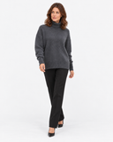 Naomi grey roll-neck jumper, walking three-quarter view