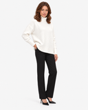 Naomi white roll-neck jumper, three-quarter full-length view