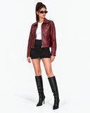 Full-length front view of the Solange red faux leather biker jacket