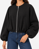 Aveline Black zip-up baseball jacket, close-up of zip and gathered sleeve
