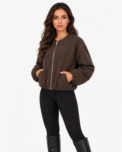 Aveline Brown zip-up baseball jacket, front view with hands in pockets
