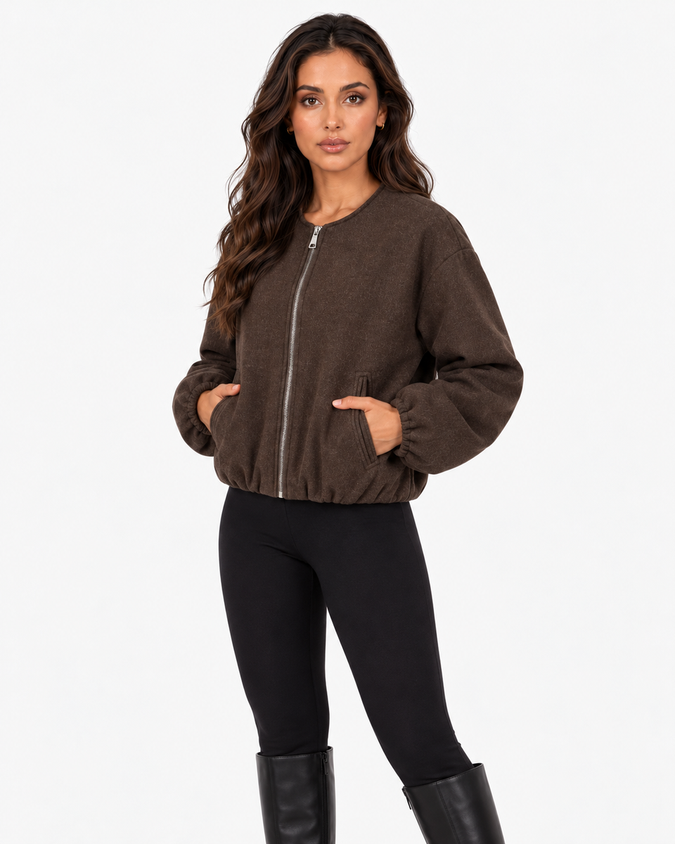 Aveline Brown zip-up baseball jacket, front view with hands in pockets