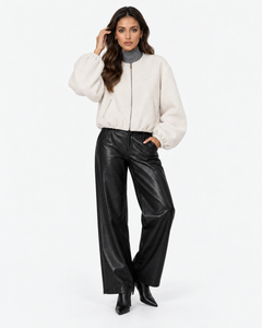 Aveline Beige zip-up baseball jacket, front view with one hand raised
