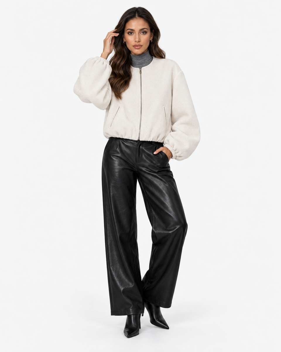 Aveline Beige zip-up baseball jacket, front view with one hand raised
