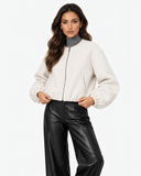 Aveline Beige zip-up baseball jacket, front pose with hands at the hem