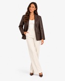 Mariette brown leather-effect blazer worn open, front view with hand in trouser pocket