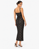 Full-length back view of a model wearing the Celina black floral lace dress
