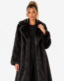Closer front view of the Claudine black faux-fur coat, showing its wide collar and texture.