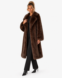 Three-quarter view of the Claudine dark brown longline faux-fur coat with wide collar.