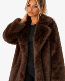 Model wearing the Claudine dark brown longline faux-fur coat, shown from the front.