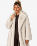 Closer front view of the Claudine cream faux-fur coat, showing its wide collar and texture.