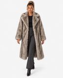 Front walking view of the Claudine taupe longline faux-fur coat on a model.