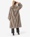 Back view of the Claudine taupe longline faux-fur coat on a model.