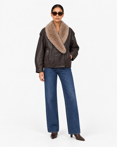 Elowen brown faux leather jacket with faux fur collar, full-length front view styled with blue jeans