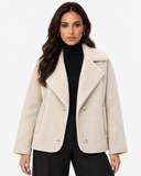 Model wearing the ivory Eveline teddy-lined suede-look jacket open over a black roll-neck top