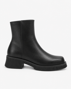 Alba black boots, side view showing the rounded front and ribbed sole edge.
