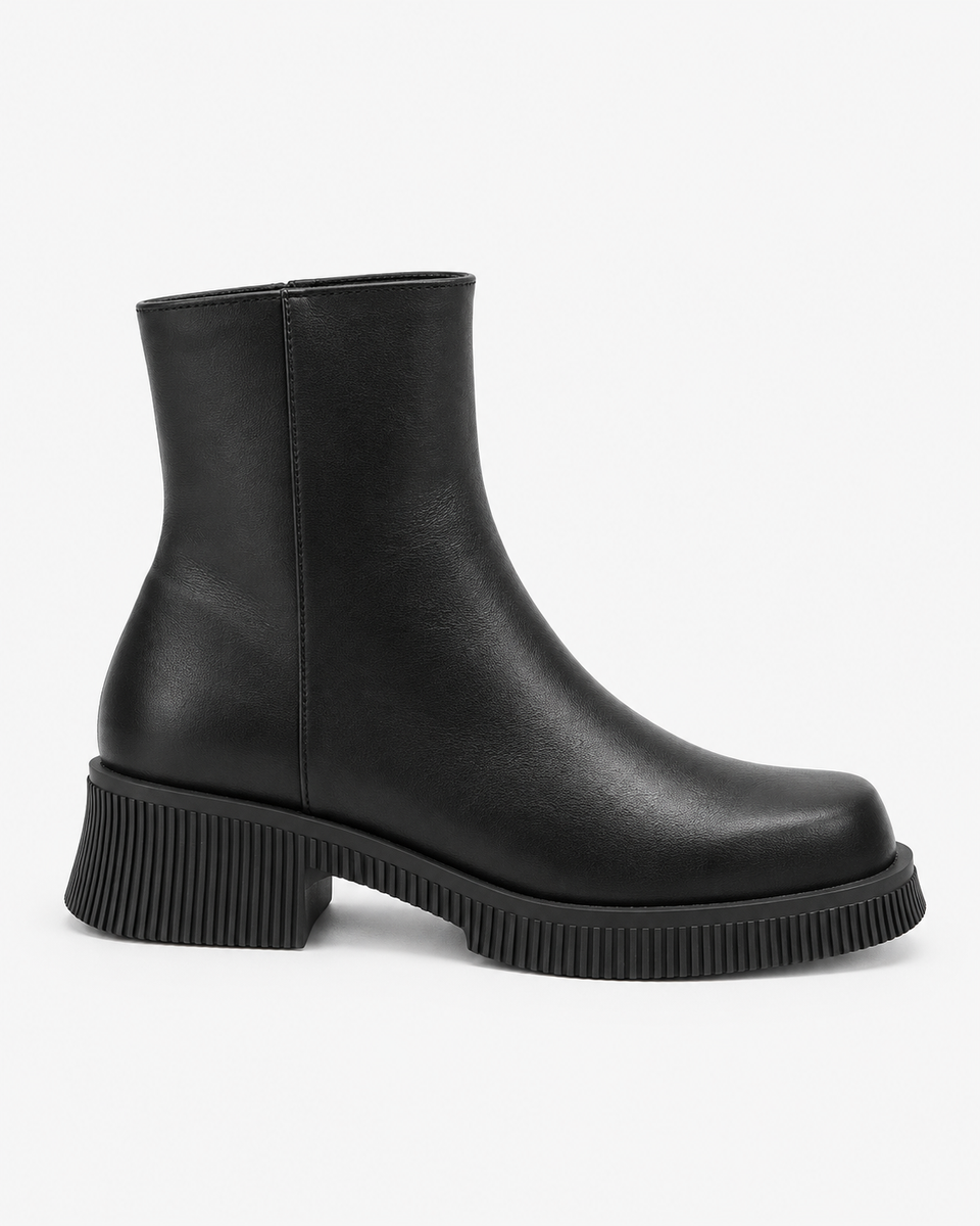 Alba black boots, side view showing the rounded front and ribbed sole edge.