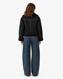 Back view of the Vespera black suede-effect biker jacket showing panel seams and textured hem