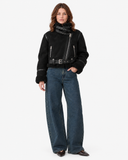 Full-length front view of the Vespera black suede-effect biker jacket fastened at the neck and waist