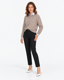 Beige round-neck knit sweater shown in a three-quarter pose over a blue shirt.