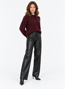 Wine-red knit sweater shown in a front pose with one hand at the hip.