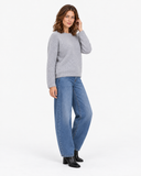 Grey knit sweater shown in a three-quarter standing pose.