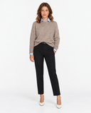 Front view of the beige knit sweater styled over a blue shirt.
