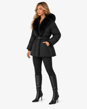 Nerina black faux fur-collar coat styled with knee-high boots, three-quarter view