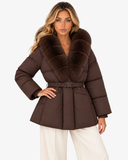 Nerina brown faux fur-collar coat with one hand on the waist, front view