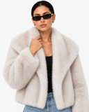 Close-up of the Solenne ivory faux-fur jacket showing its textured collar