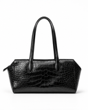 Front view of a black crocodile-pattern tote bag with twin handles on a white background.
