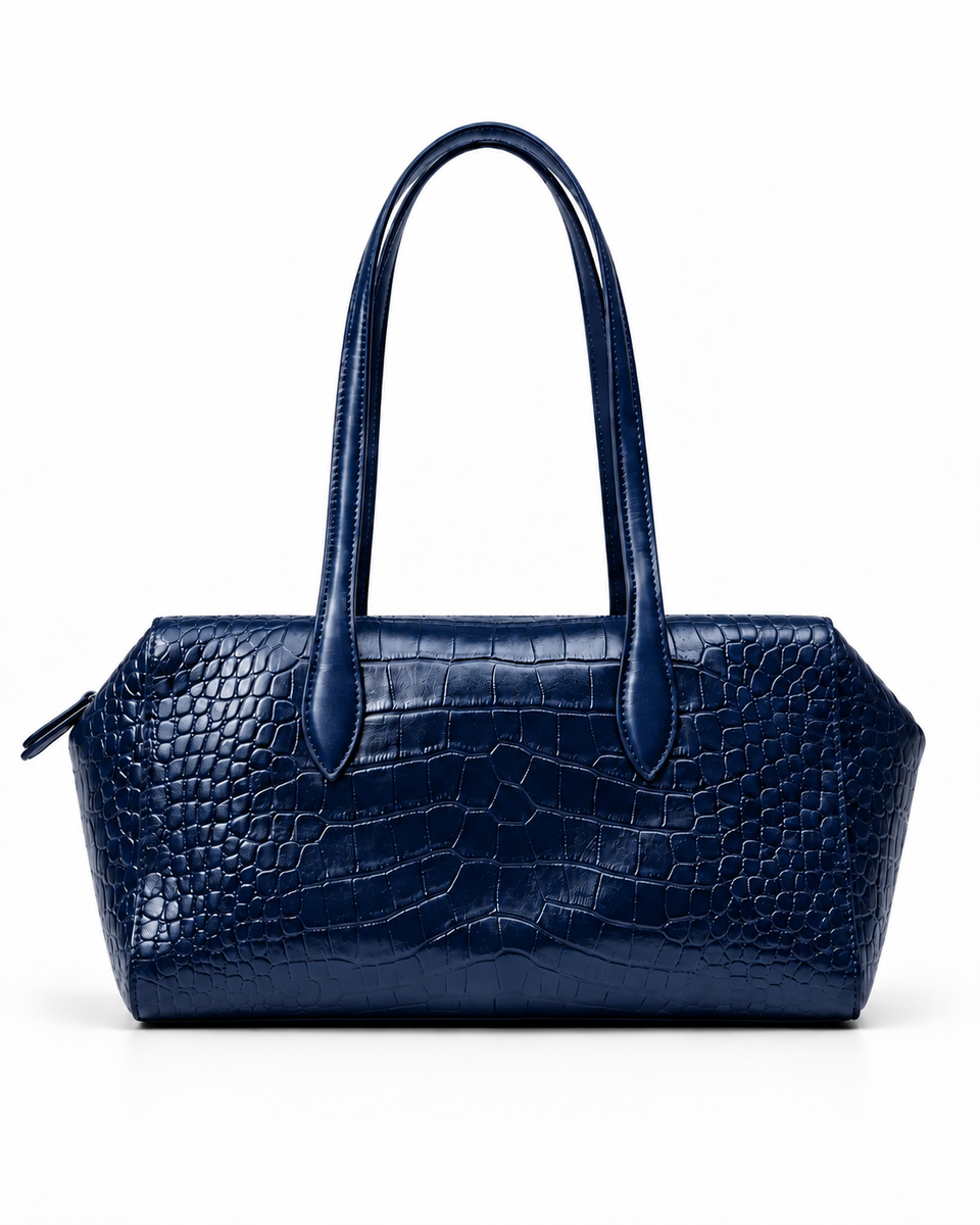 Front view of a dark blue crocodile-pattern tote bag with twin handles against a white background.