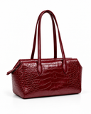 Three-quarter view of an Ankela Red crocodile-pattern tote bag showing its structured side and long handles.