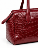 Close-up of the Ankela Red crocodile-pattern finish, side panel, zip pull and handle attachment.