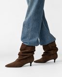 Thea brown boots, worn with wide-leg jeans.