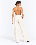 Back view showing the open back of the Aurelie gold chainmail halter top.
