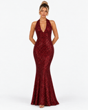 Front pose variation of the Virelle wine red sequin halter maxi dress with hands behind the waist.