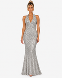 Front view of the Virelle silver sequin halter maxi dress with a plunging neckline and flared hem.